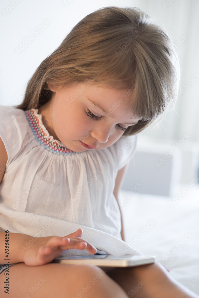 Cute Little girl using mobile phone at home Cute Little girl using mobile phone at home