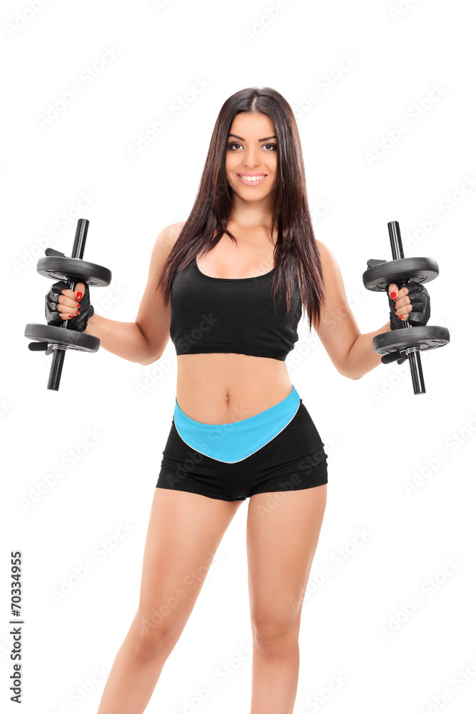 Sexy girl in sportswear exercising with two barbells