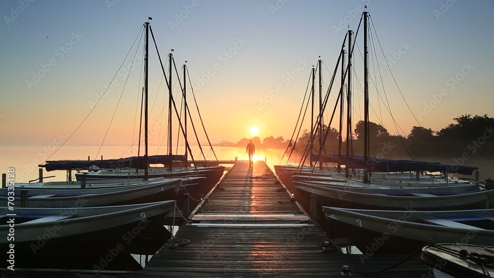 Walking on a jetty during sunrise. Walking on a jetty during sunrise.