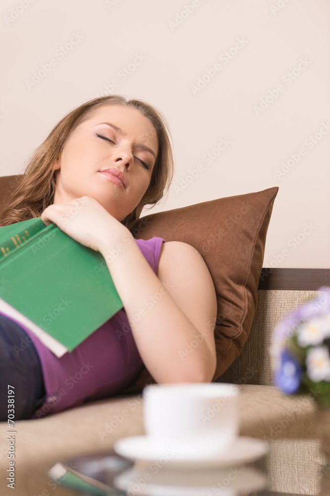 beautiful young woman sleeping on sofa at home. beautiful young woman sleeping on sofa at home.