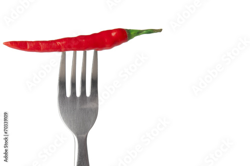 Red hot chili pepper impaled on steel fork © unclepodger