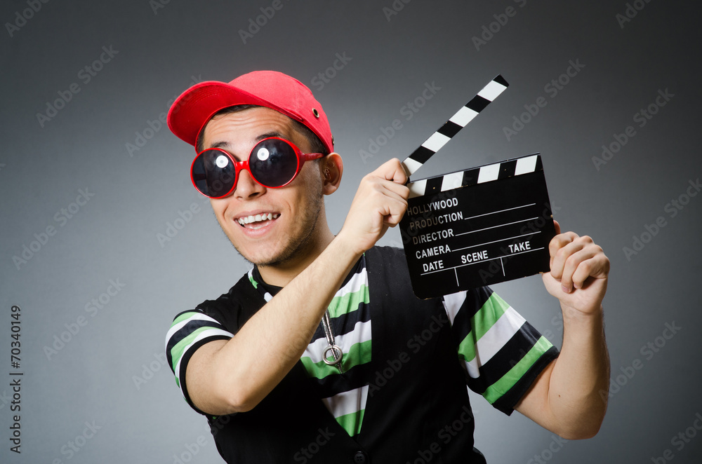 Man with baseball cap and movie board Man with baseball cap and movie board