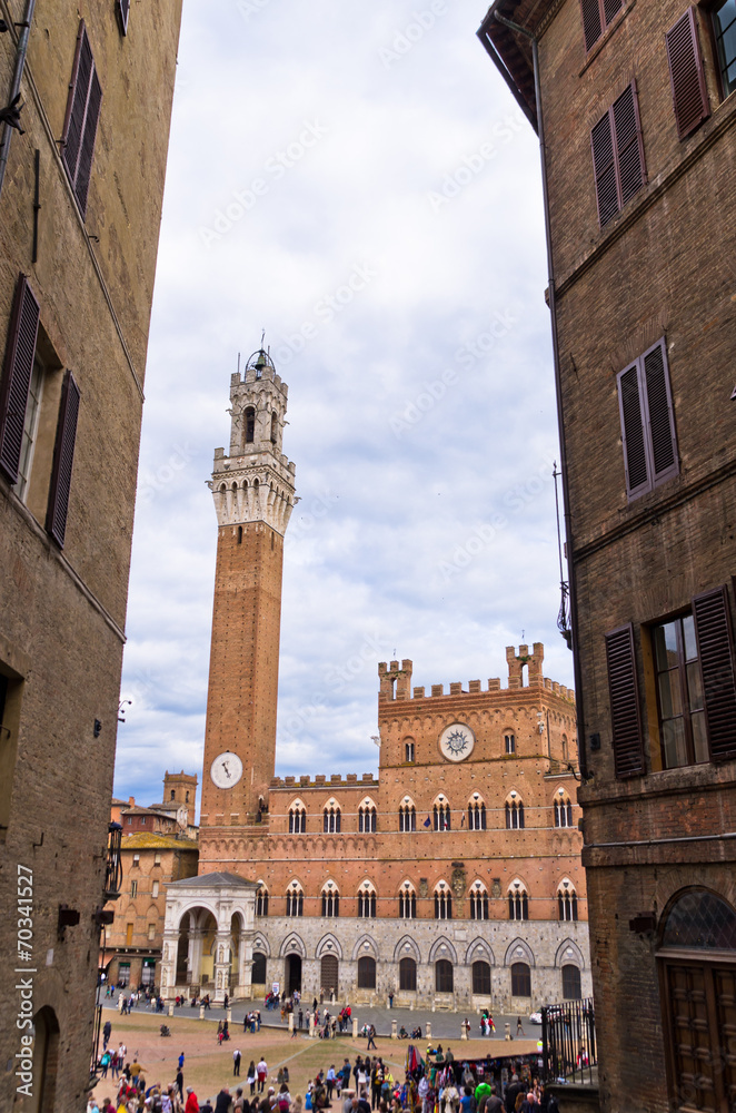 Clock tower of a city hall on main square in Siena