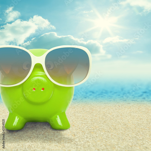 Piggy bank in sunglasses on the beach - 1 to 1 ratio