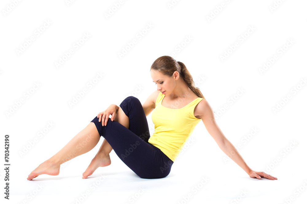 Young beautiful woman posing in a gym outfit