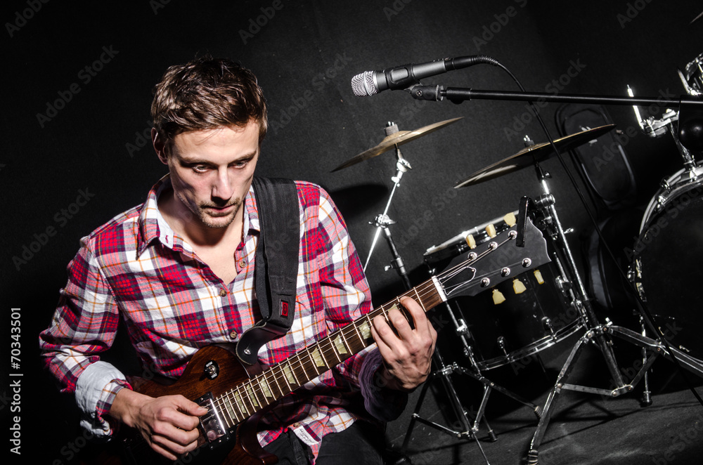 Fototapeta premium Man with guitar during concert