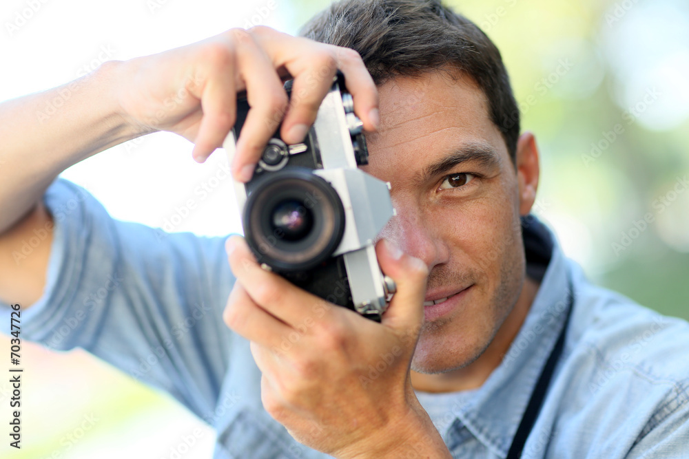 Photographer shooting outside with old camera Photographer shooting outside with old camera