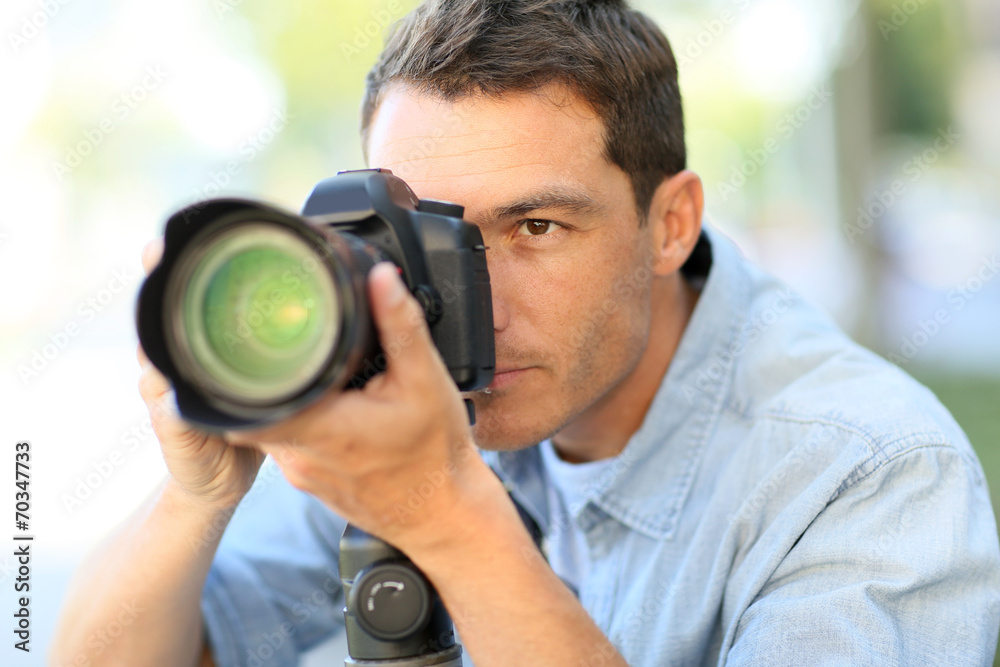 Photographer using reflex camera outside Photographer using reflex camera outside
