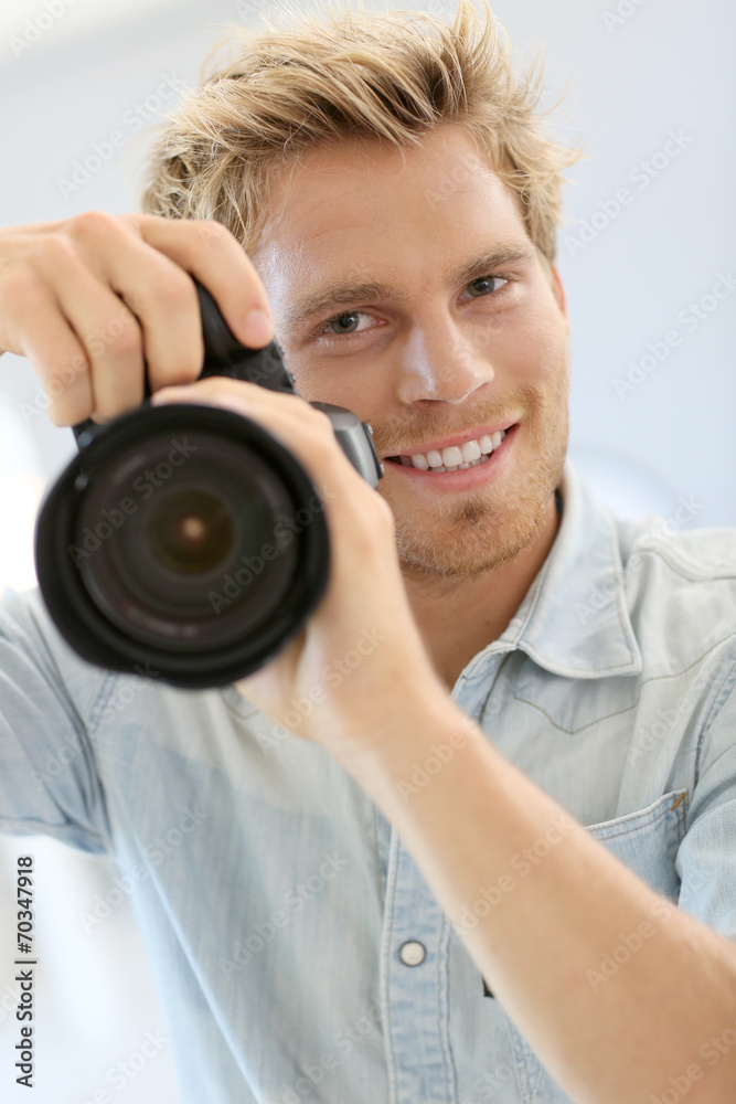 Fashion photographer shooting model in studio Fashion photographer shooting model in studio
