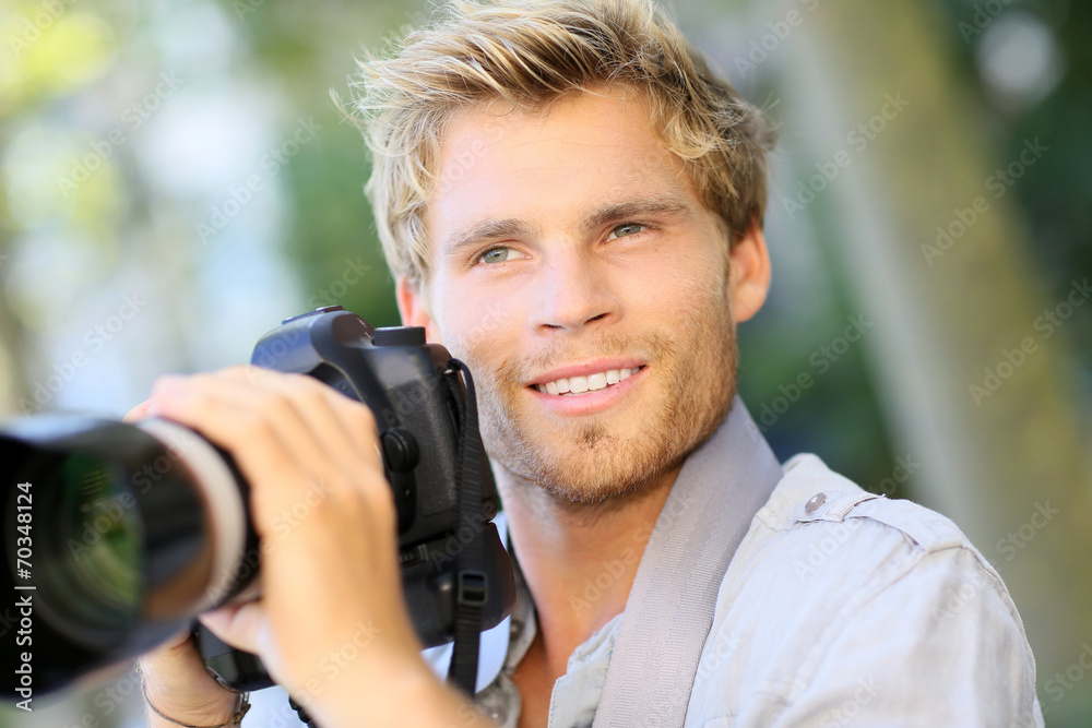 Young photographer shooting with digital camera Young photographer shooting with digital camera