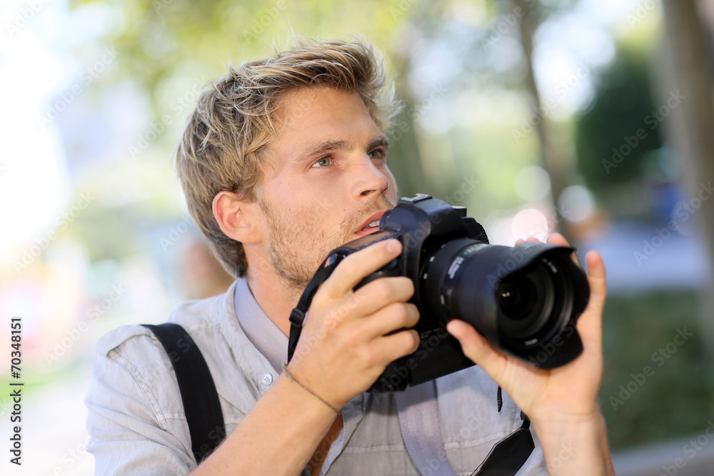 Photographer shooting outside with digital camera Photographer shooting outside with digital camera