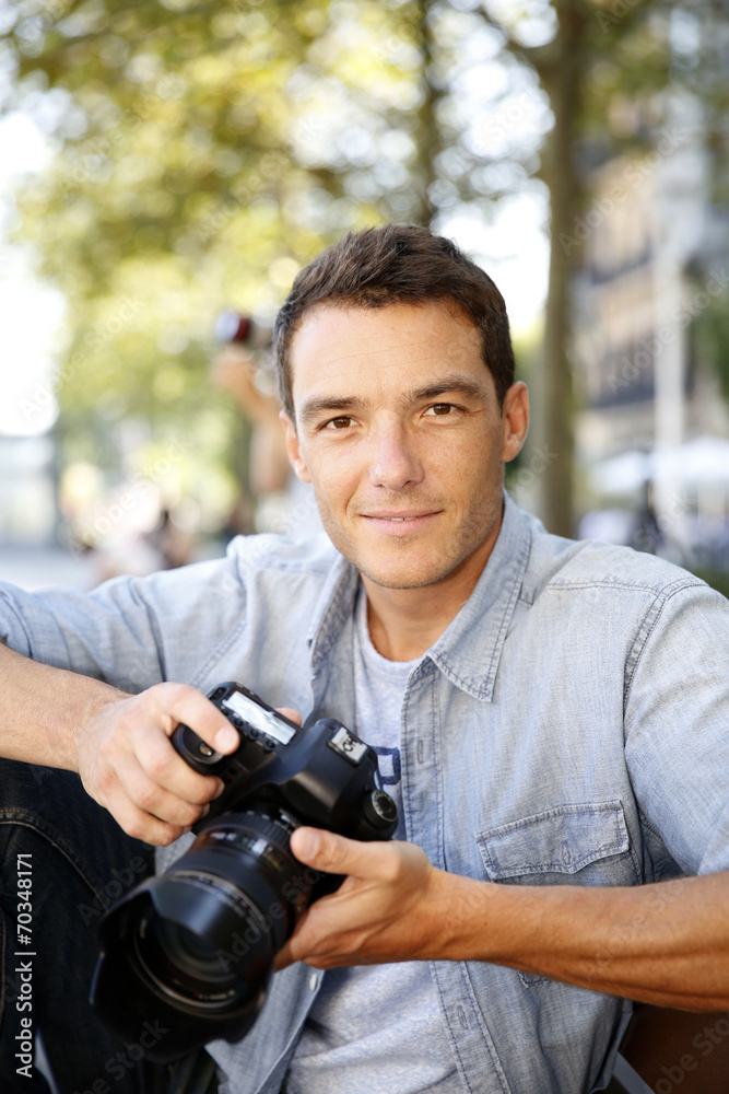 Photographer taking pictures in the street Photographer taking pictures in the street
