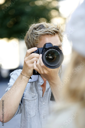 Photographer photographing fashion model in street