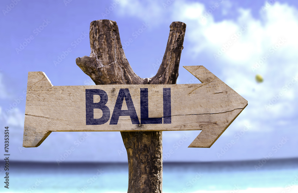 Bali wooden sign with a beach on background