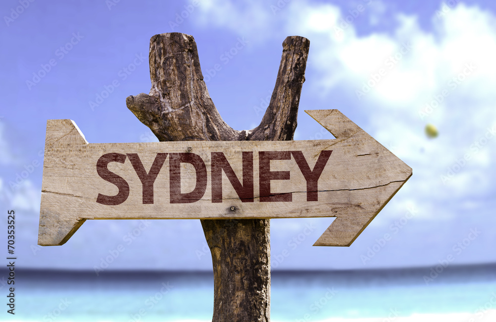 Sydney wooden sign with a beach on background