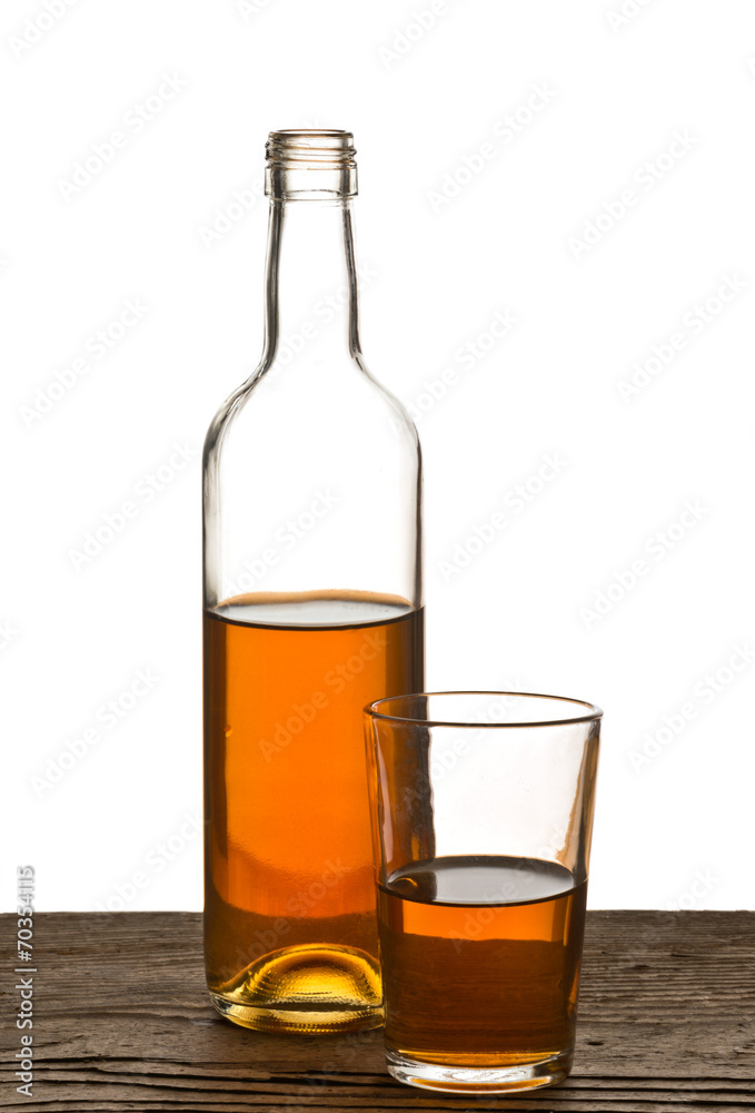 glass and bottle of brandy isolated on the white glass and bottle of brandy isolated on the white
