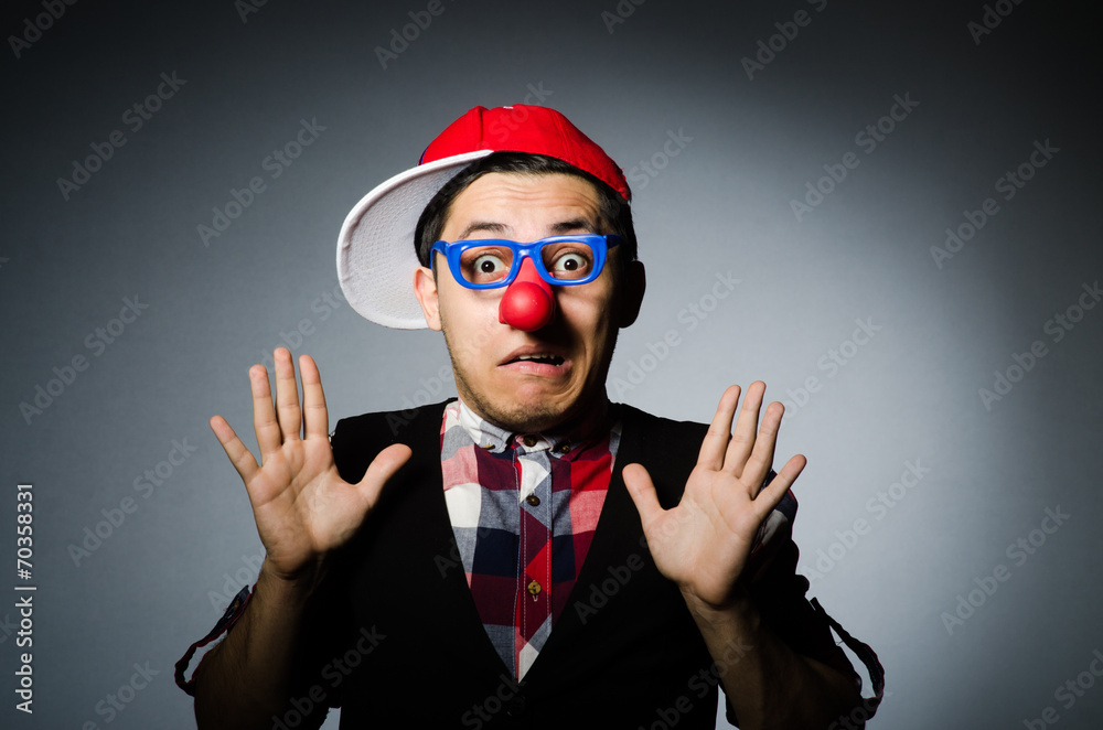 Funny clown against the dark background Funny clown against the dark background