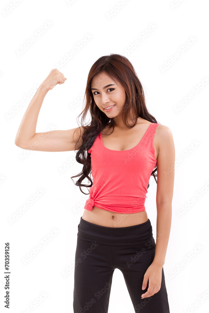 young sporty woman showing, checking her biceps arm muscle