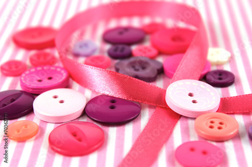 Pink and purple haberdashery buttons and craft ribbon photo