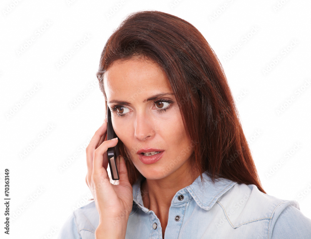 Adult hispanic woman conversing on her cell Adult hispanic woman conversing on her cell