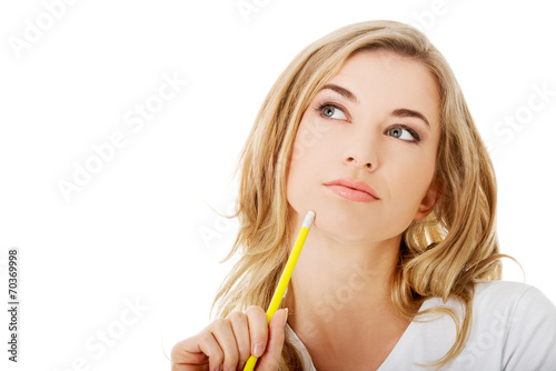 Thoughtful woman with pencil