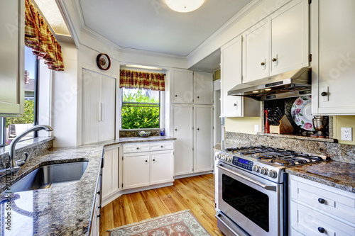 White kitchen cabinets with granite tops
