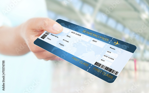 hand holding air ticket on airport