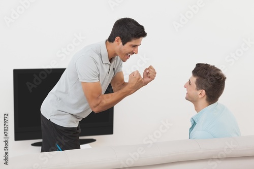 Excited soccer fans watching tv