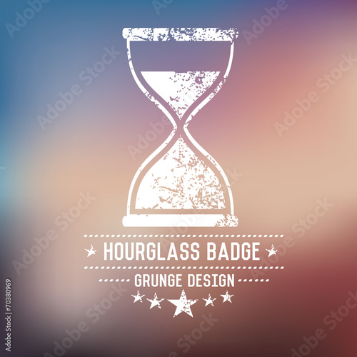 Hourglass badge grunge symbol on blur background