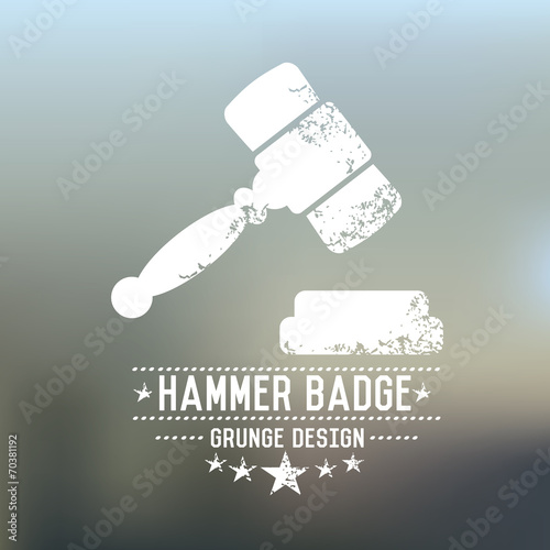 Hammer badge grunge symbol on blur background