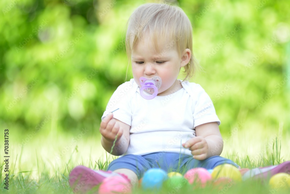 Cute baby playing on grass in garden. Cute baby playing on grass in garden.