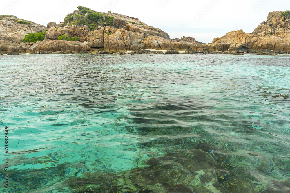 Fototapeta premium Rock island and clear water with low angle view