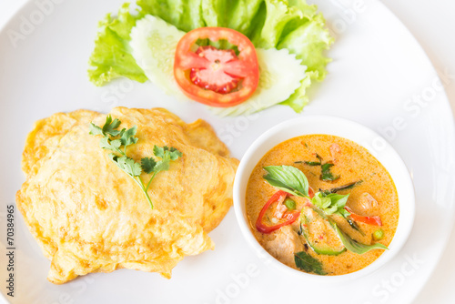 Delicious rice and red curry with pork and omelet (Thai panang c