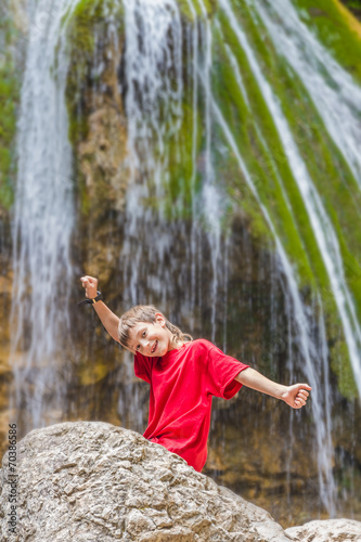 Fototapeta Naklejka Na Ścianę i Meble -  young happy smiling child boy on waterfall background
