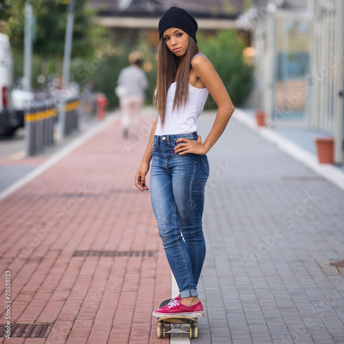 Teenager with skateboard full body portrait.