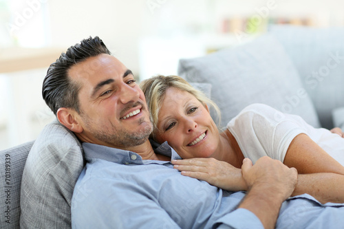 Mature couple relaxing in sofa at home
