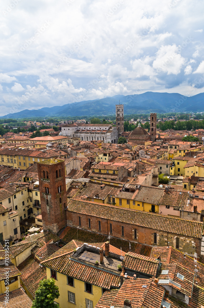 Cityscape of Lucca with cathedral and nearby mountains, Tuscany