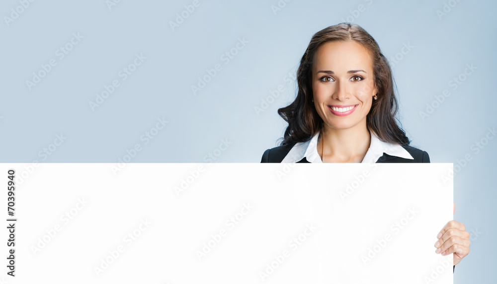 Businesswoman showing signboard, over blue Businesswoman showing signboard, over blue