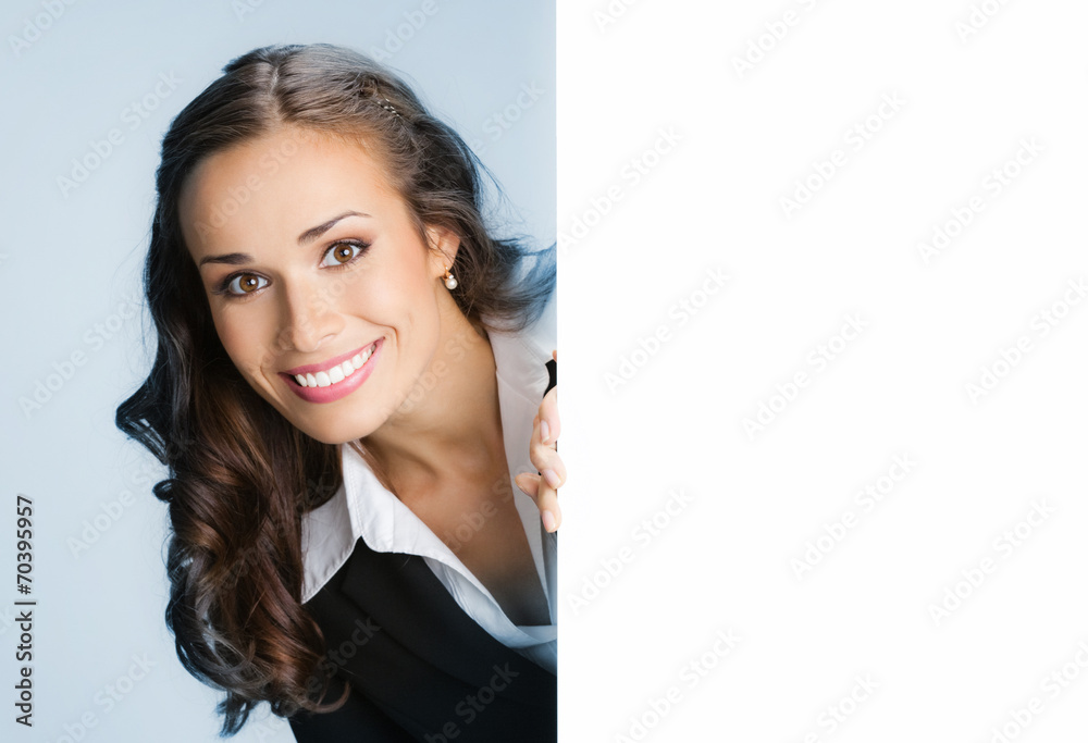 Businesswoman showing signboard, over blue Businesswoman showing signboard, over blue