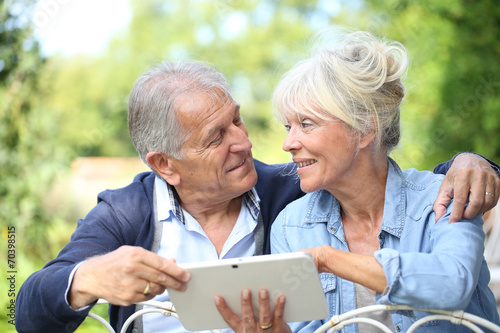 Senior couple connected on digital tablet