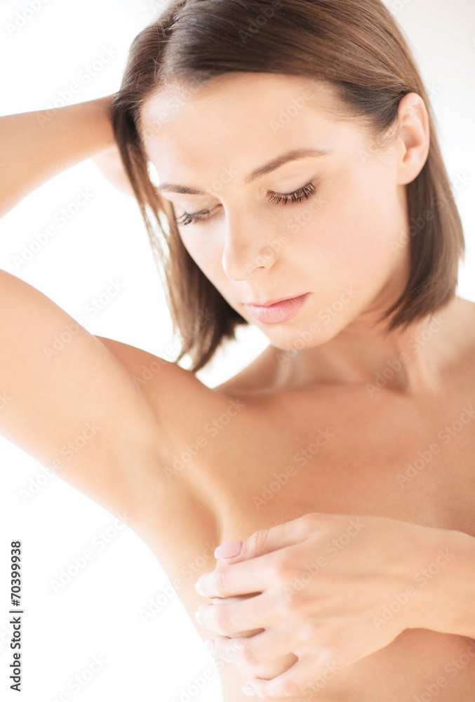 woman checking breast for signs of cancer woman checking breast for signs of cancer