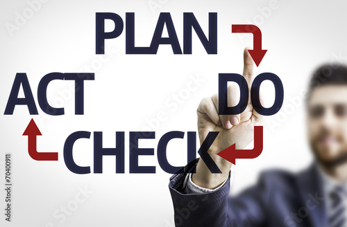 Business man pointing the text: Plan Do Check Act photo