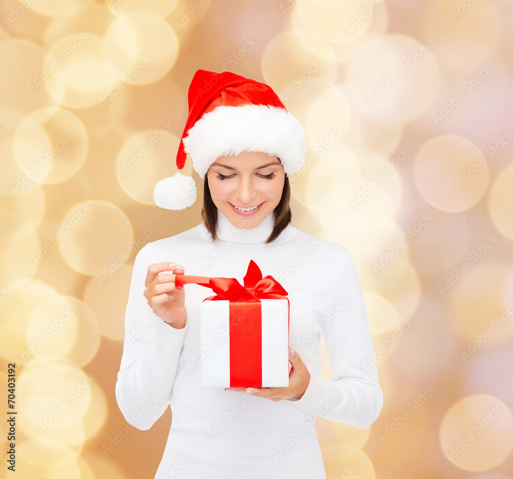 smiling woman in santa helper hat with gift box smiling woman in santa helper hat with gift box