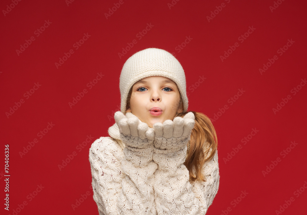 happy girl in winter clothes blowing on palms happy girl in winter clothes blowing on palms
