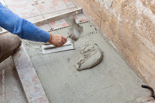 Tiler works with flooring.