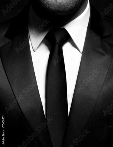 Man gentleman in black suit and tie