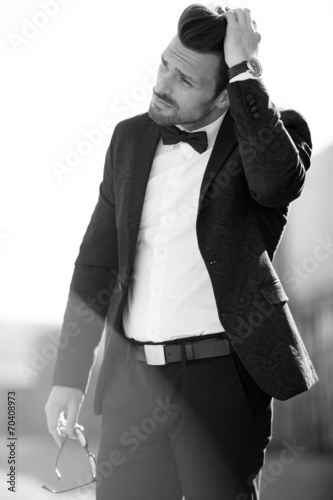 Artistic photo of a man in suit with natural lit dust