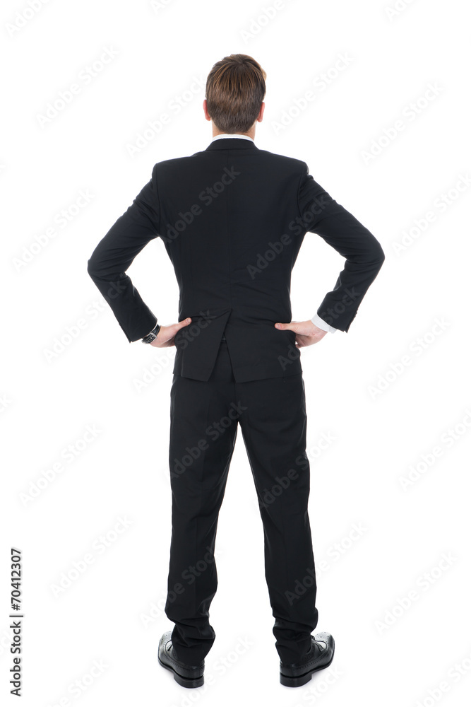 Confident Businessman Standing With Hands On Hips Confident Businessman Standing With Hands On Hips