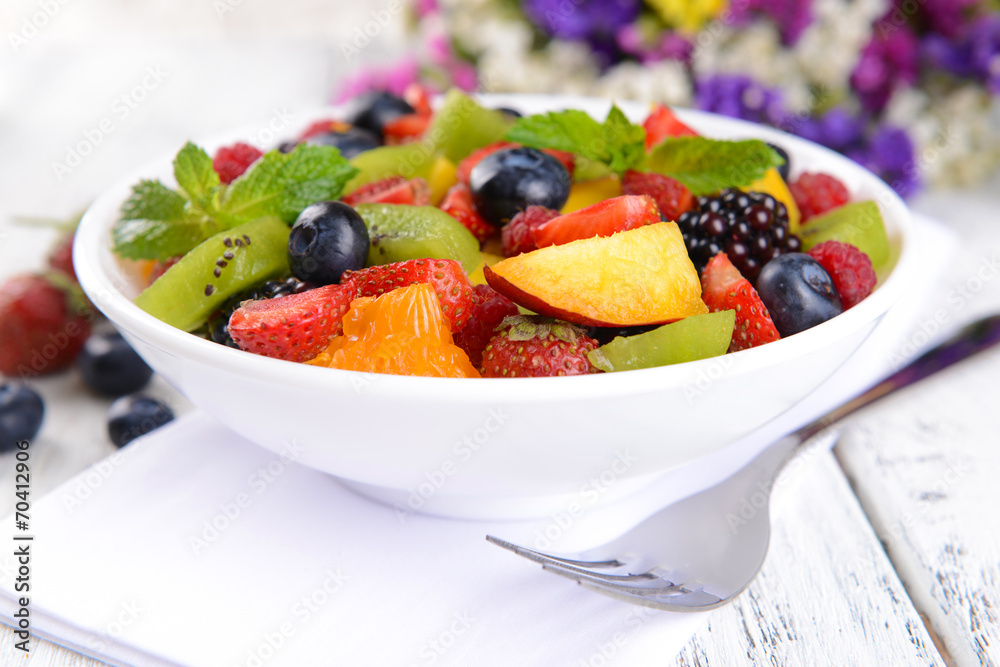 Delicious fruits salad in plate on table close-up