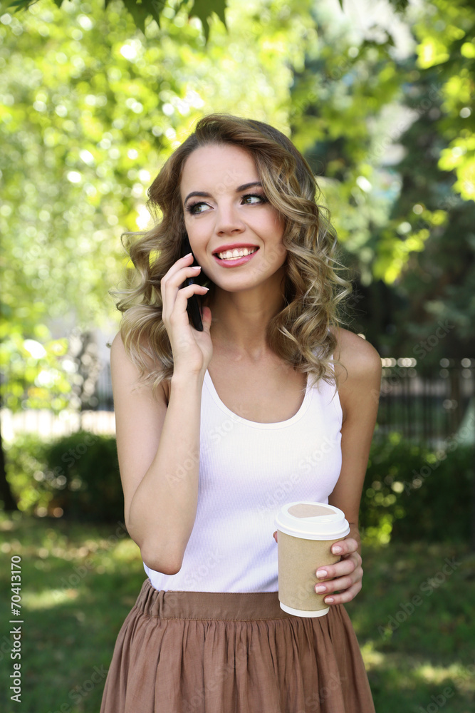 Beautiful young girl with coffee on city street Beautiful young girl with coffee on city street